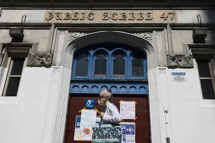 A person walks past a New York City public school in New York.
